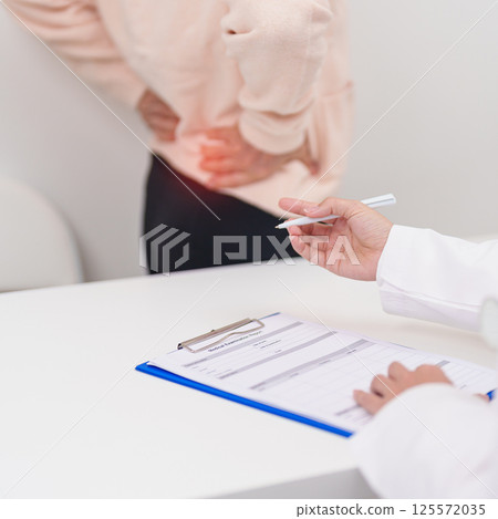 Elderly woman having back body ache and consulting doctor in hospital. Senior female with muscle pain due to Piriformis Syndrome, Low Back Pain and Spinal Compression. Office syndrome and medical 125572035