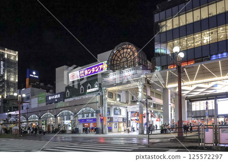 March 23 2025 March 23 2025 Bustling Urban Shopping District at Night with People March 23 2025 March 23 2025 Bustling Urban Shopping District at Night with People 125572297