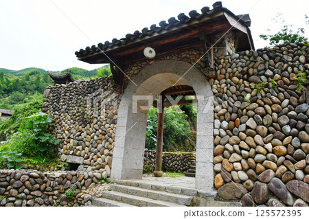 traditional Chinese style door on stone wall, China, Zhejiang Province 125572395
