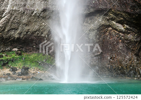 a waterfall falling into a lake, Zhejiang Province, China 125572424