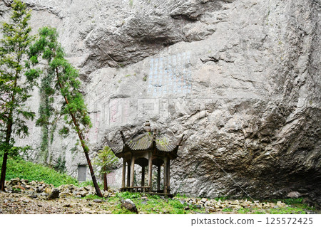 a traditional Chinese style pavilion under the cliff, Zhejiang Province, China 125572425