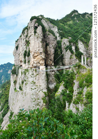 a suspension bridge on the edge of a cliff in the mountains, Zhejiang Province, China a suspension bridge on the edge of a cliff in the mountains, Zhejiang Province, China 125572436