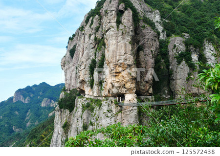 a suspension bridge on the edge of a cliff in the mountains, Zhejiang Province, China a suspension bridge on the edge of a cliff in the mountains, Zhejiang Province, China 125572438