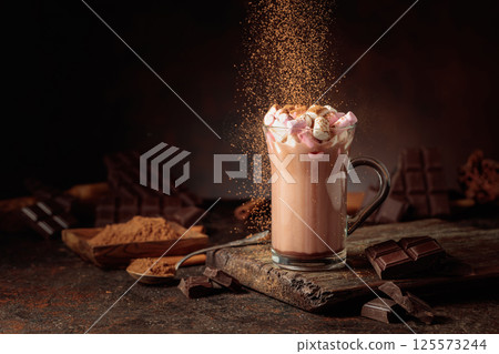Hot chocolate drink with marshmallows sprinkled with cocoa powder. Hot chocolate drink with marshmallows sprinkled with cocoa powder. 125573244