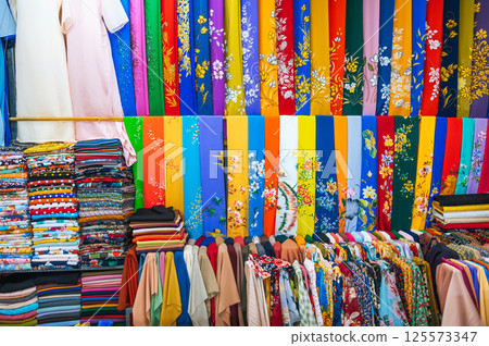 clothing and fabrics at textile market bazaar in Asia in Vietnam 125573347