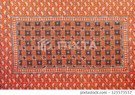 traditional Uzbek geometric pattern on ancient vintage carpet in Uzbekistan. Oriental background with beautiful ornaments traditional Uzbek geometric pattern on ancient vintage carpet in Uzbekistan. Oriental background with beautiful ornaments 125573537