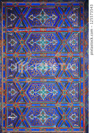 carved wooden painted ceiling in the Museum of Art of Uzbekistan with traditional Uzbek ornaments and oriental patterns in Tashkent 125573543