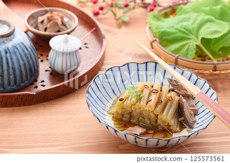 Spring wild vegetable dish: Boiled butterbur and raw dried fish Spring wild vegetable dish: Boiled butterbur and raw dried fish 125573561