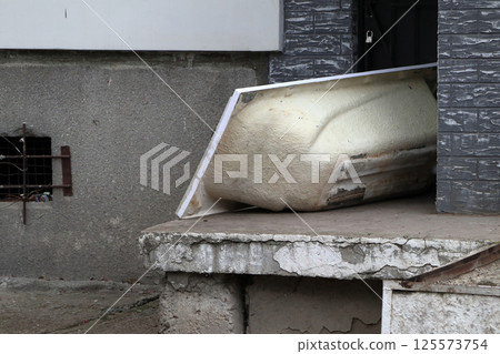 Abstract composition with an old acrylic bathtub. Abstract composition with an old acrylic bathtub. 125573754