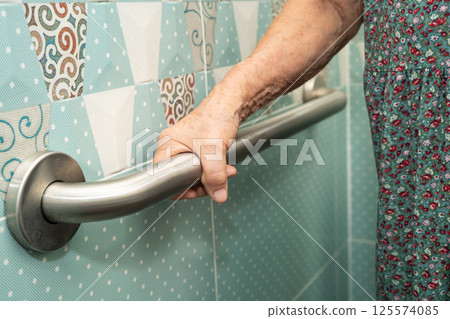 Asian elderly woman patient use toilet bathroom handle security in nursing hospital, healthy strong medical. Asian elderly woman patient use toilet bathroom handle security in nursing hospital, healthy strong medical. 125574085