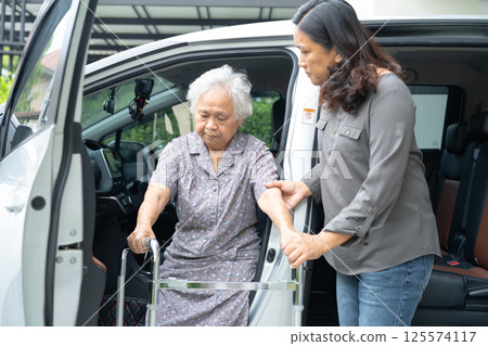 Asian senior woman patient sitting on walker prepare get to her car, healthy strong medical concept. 125574117