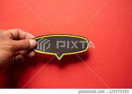 Black speech bubble on a red background Black speech bubble on a red background 125575583