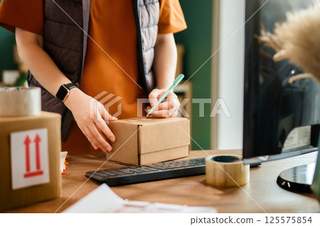 Woman working in a warehouse. 125575854