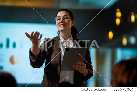 A woman is speaking on stage A woman is speaking on stage 125575864