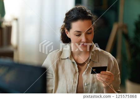 Woman is doing online purchases Woman is doing online purchases 125575868