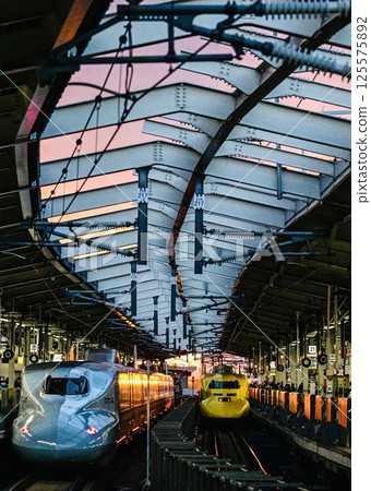 Doctor Yellow in the setting sun and the Shinkansen waiting to depart 125575892