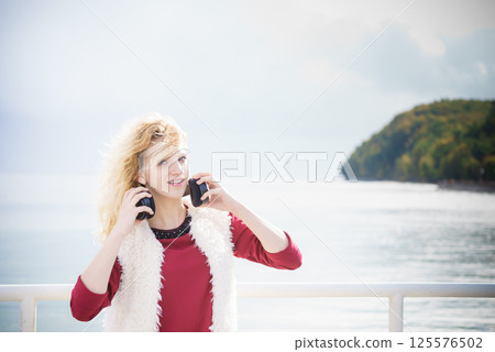 Happy woman wearing headphones outdoor Happy woman wearing headphones outdoor 125576502