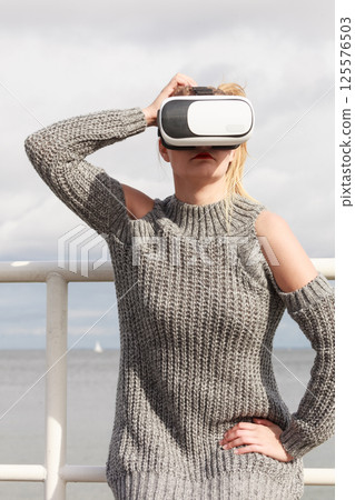 Woman wearing VR outside Woman wearing VR outside 125576503