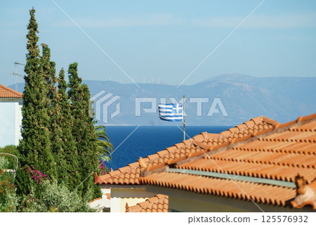 Greek flag on roof top of home Greek flag on roof top of home 125576932