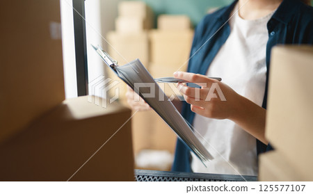 Woman working in a warehouse. 125577107