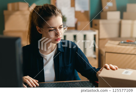 Woman working in a warehouse. Woman working in a warehouse. 125577109