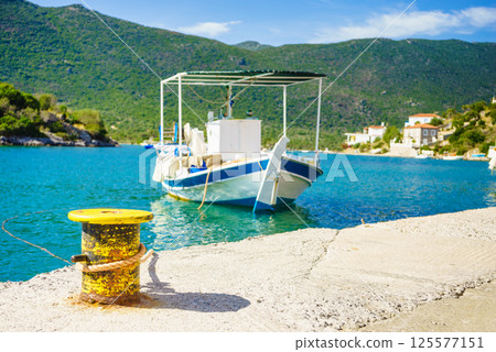 Jetty pier on coastline with boat yacht. 125577151