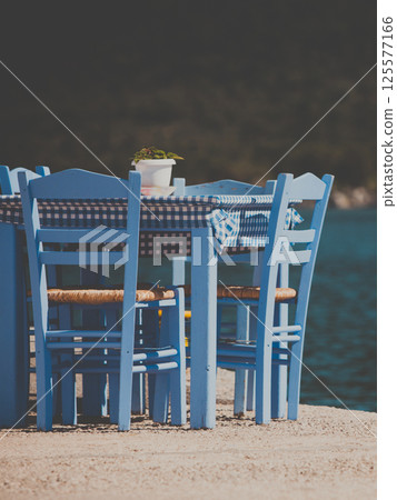 Open cafe outdoor restaurant in Greece on sea shore Open cafe outdoor restaurant in Greece on sea shore 125577166