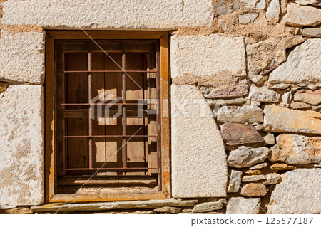 Old rustic window with grilles 125577187