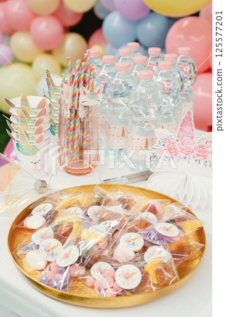 Unicorn-Themed Party Table with Treats and Decorations 125577201