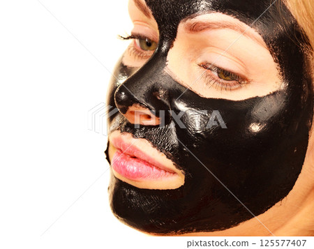 Girl black carbo peel off mask on face Girl black carbo peel off mask on face 125577407