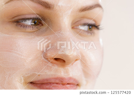 Girl with cream moisture cosmetic on face Girl with cream moisture cosmetic on face 125577420