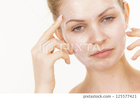 Girl with cream moisture cosmetic on face Girl with cream moisture cosmetic on face 125577421