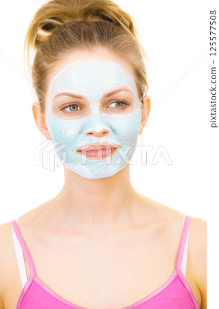 Girl with green mud mask on face Girl with green mud mask on face 125577508