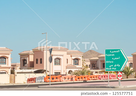 Villa's, House or Home with their cream color, Villa's with black glass windows, Palm-trees front of House Villa's, House or Home with their cream color, Villa's with black glass windows, Palm-trees front of House 125577751