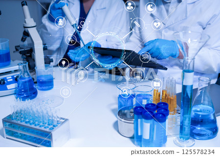 Lab work, Doctor holds a test tube takes the test from a test tube in analysis. Lab work, Doctor holds a test tube takes the test from a test tube in analysis. 125578234