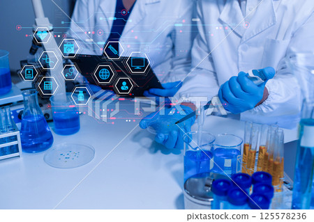 Lab work, Doctor holds a test tube takes the test from a test tube in analysis. Lab work, Doctor holds a test tube takes the test from a test tube in analysis. 125578236