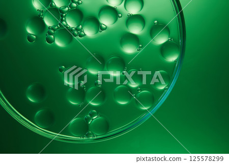 Macro mineral water with molecules arranged next to each other, surrounded by tiny particles. The molecules are round, transparent. Light shines on the molecules, making them stand out and sparkle. 125578299