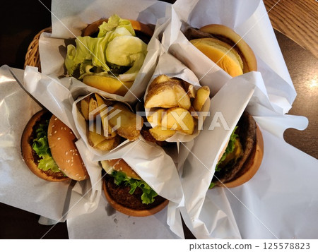 Huge serving of fresh burgers and fries Huge serving of fresh burgers and fries 125578823