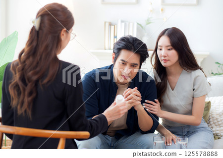 Asian couple counseling of therapist for support and guidance about depression with stress and worry 125578888