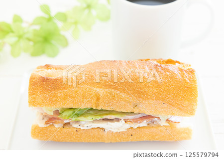 A delicious chicken and bacon Parisian sandwich and hot coffee for breakfast 125579794