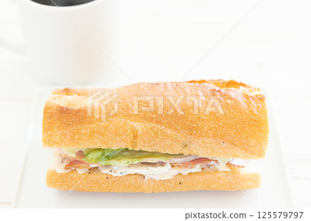 A delicious chicken and bacon Parisian sandwich and hot coffee for breakfast 125579797