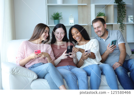 Happy inrterracial group of friends checking phones 125580466