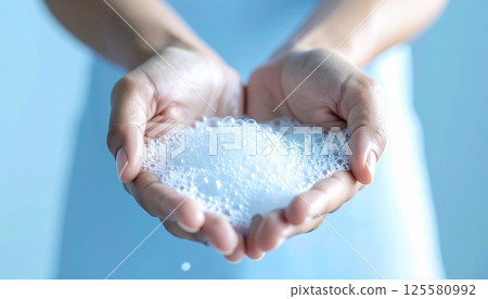 Fluffy foam spreads across the palm of your hand3 125580992