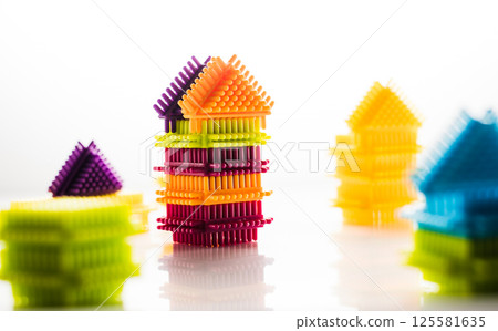 A children's construction set combines colorful blocks of various geometries. The bright elements of the play-constructor spark interest in creative activities.  125581635