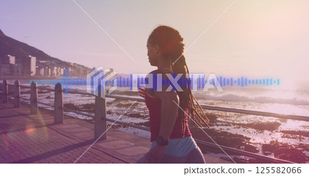 Image of blue lines over biracial woman running on promenade 125582066