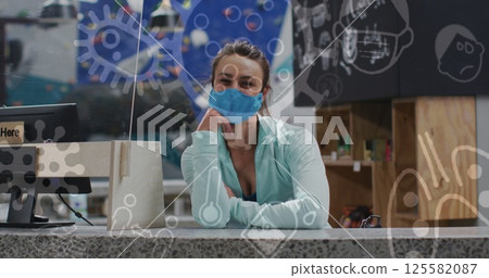 Image of coronavirus icons over caucasian woman with face mask on climbing wall 125582087