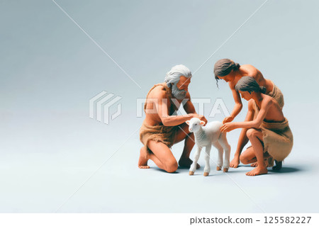 Primitive people stroking a small sheep. Space for text. 125582227