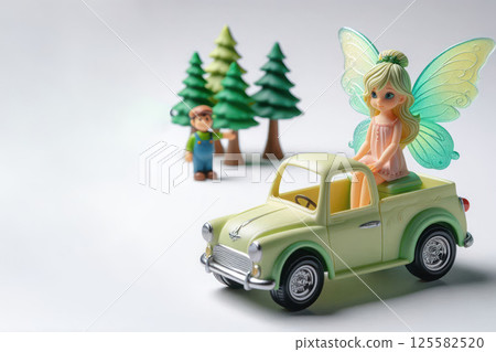 The fairy is sitting on a toy car. Space for text. 125582520