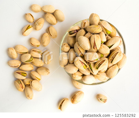 Roasted pistachios on white background Roasted pistachios on white background 125583292