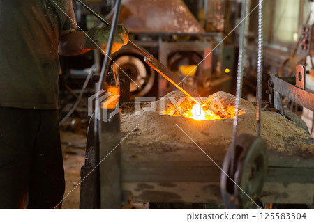 Ferrous metal billet is melted in an induction furnace closeup Ferrous metal billet is melted in an induction furnace closeup 125583304